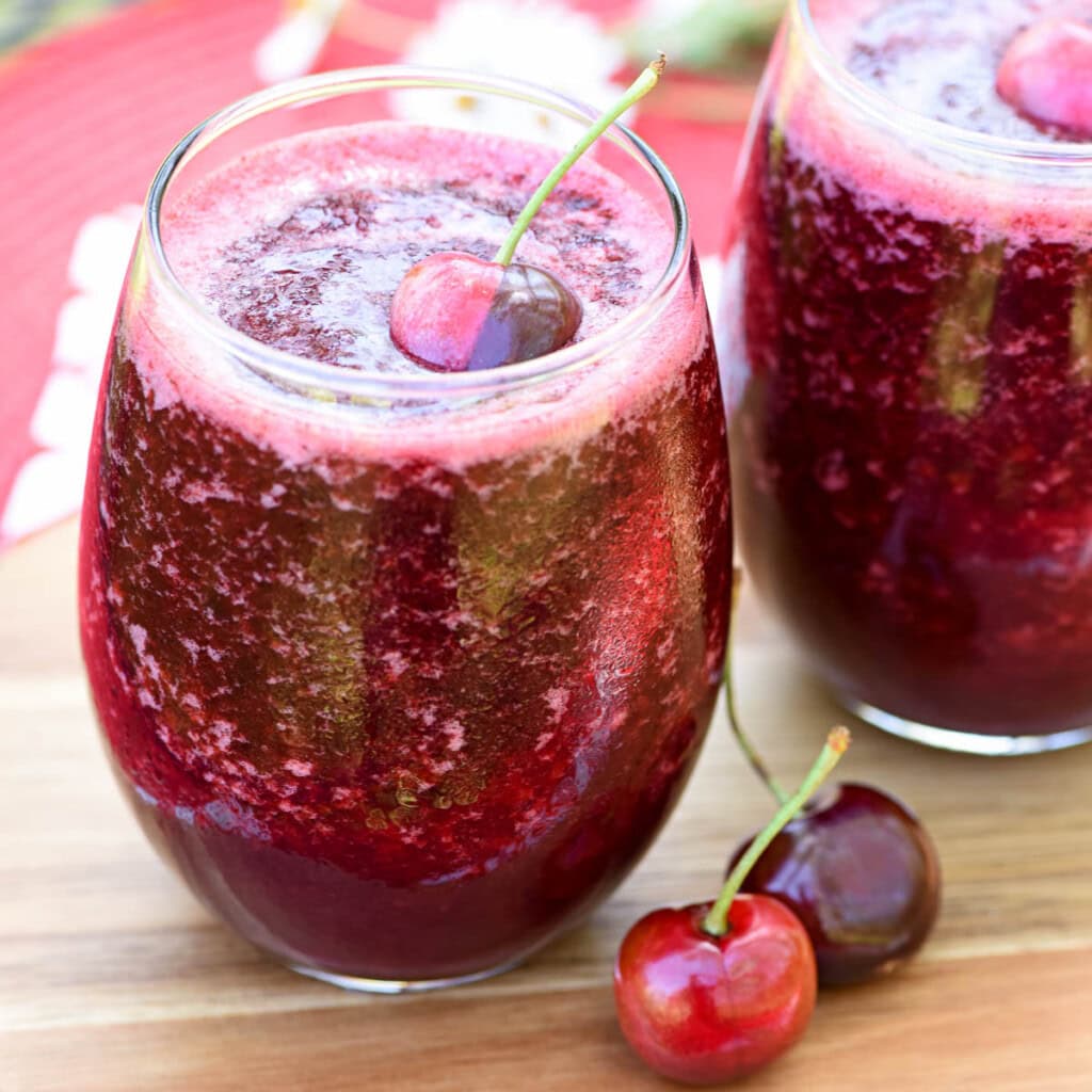 Wine slushies on table with fresh fruit garnish.