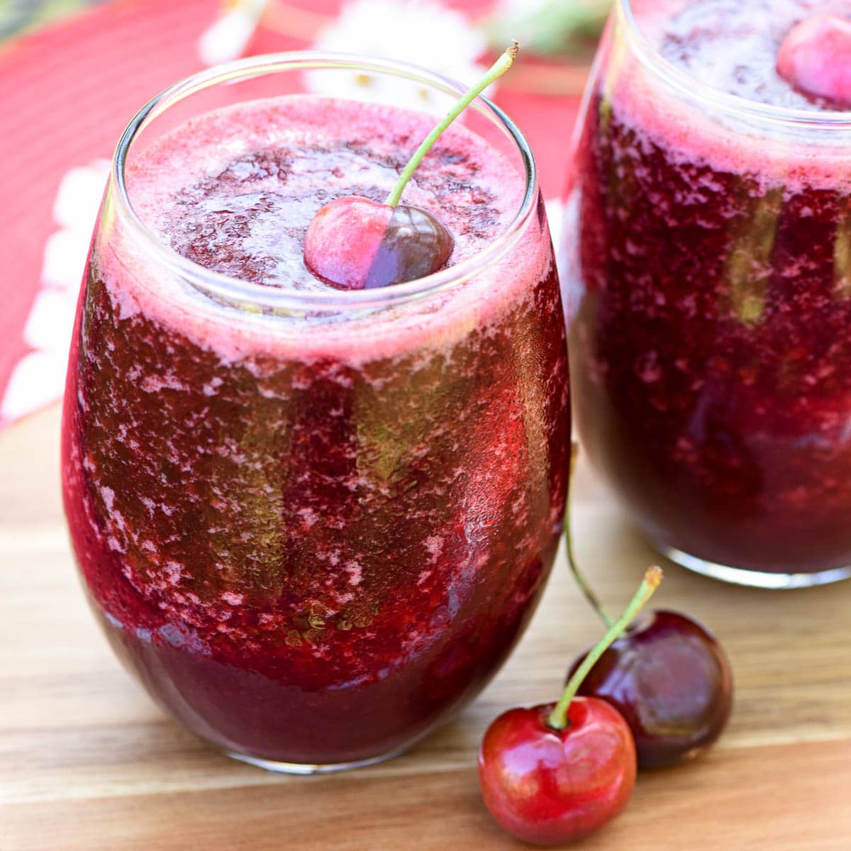 Wine slushies on table with fresh fruit garnish.