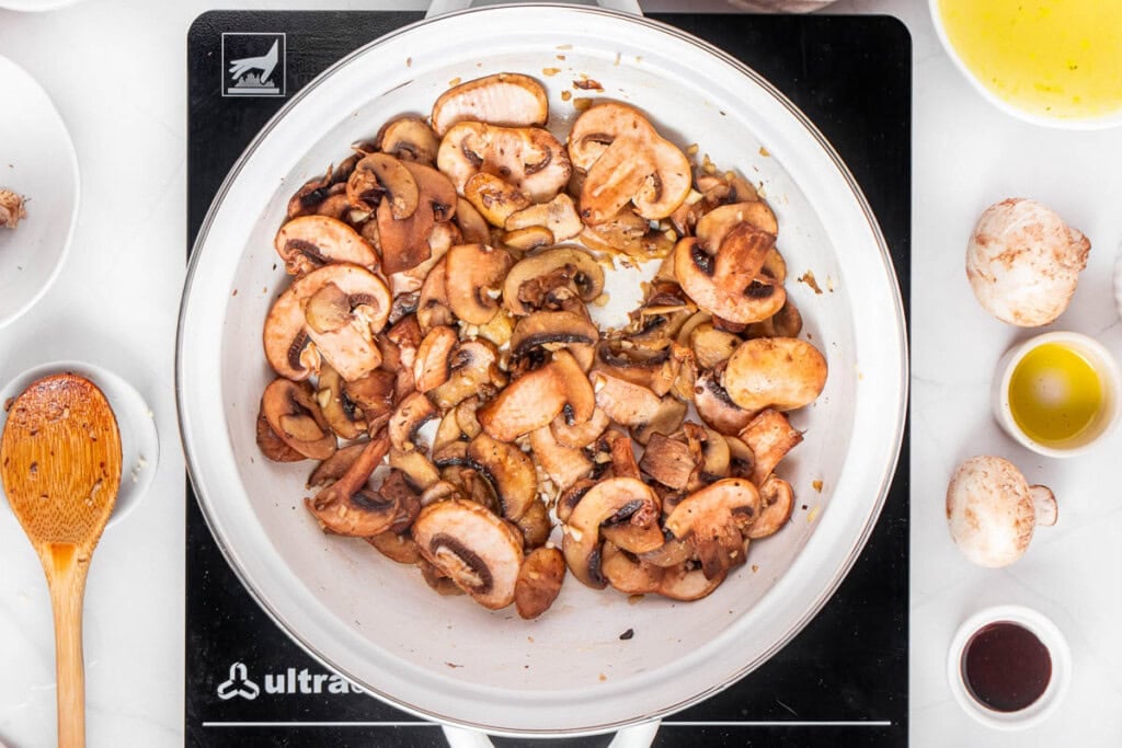 Sauteed mushrooms for green bean casserole with fresh green beans.