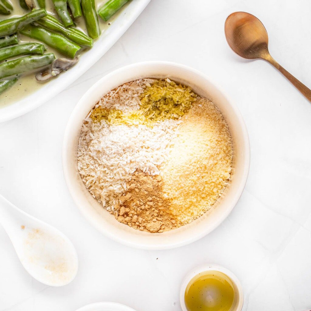Combining Panko, Parmesan, seasonings, and oil in bowl.