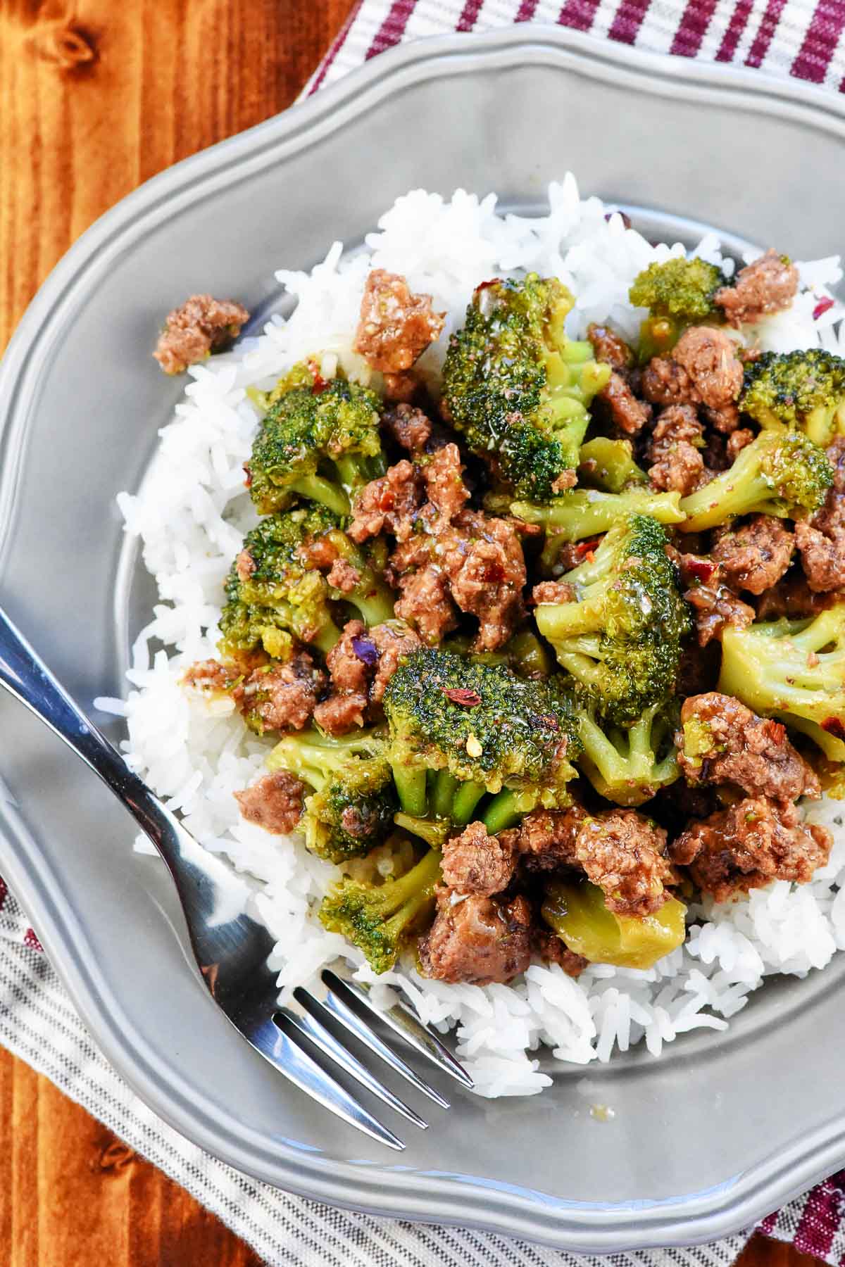 Aerial view of Ground Beef and Broccoli over rice on plate.