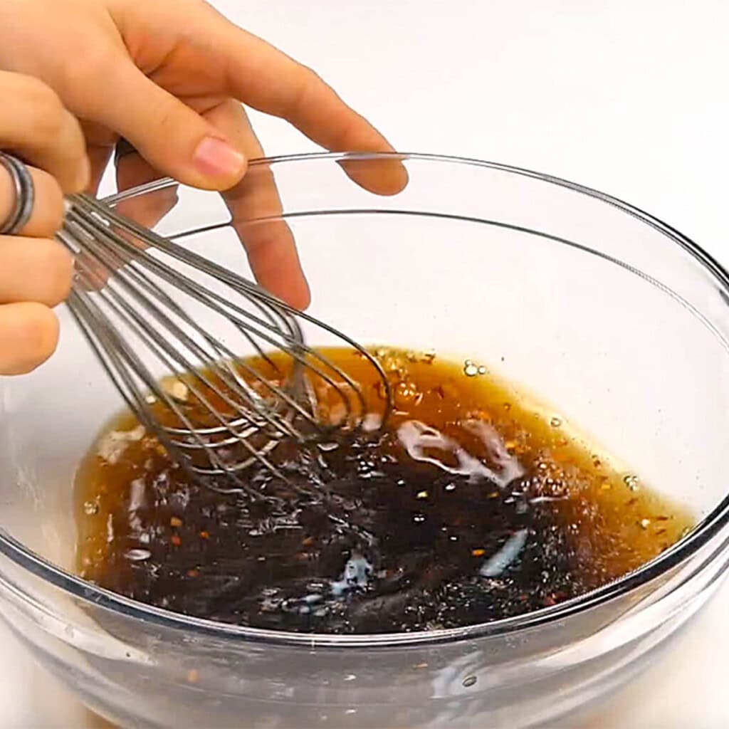 Whisking sauce ingredients for easy ground beef recipes.