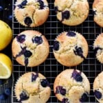 Lemon Blueberry Muffins aerial view on cooling rack with lemons.