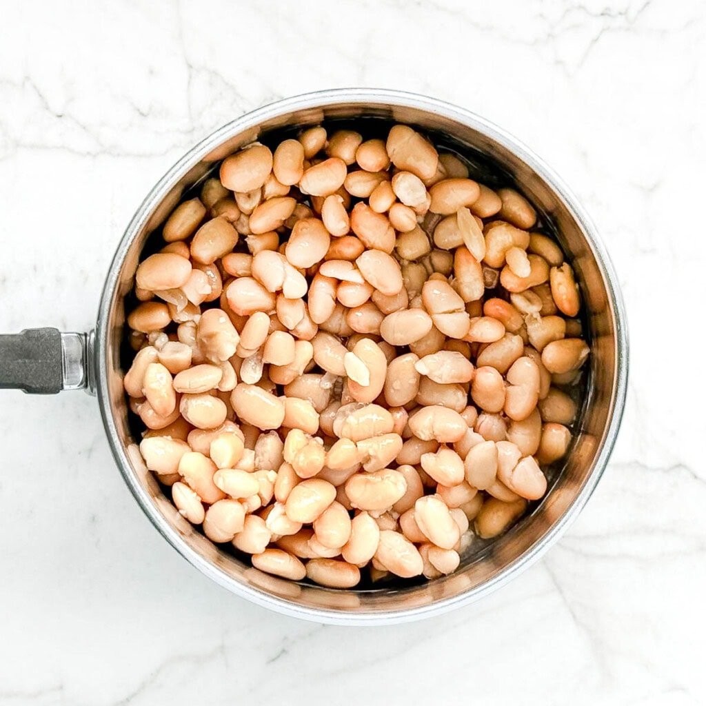 Canned white beans in pot.