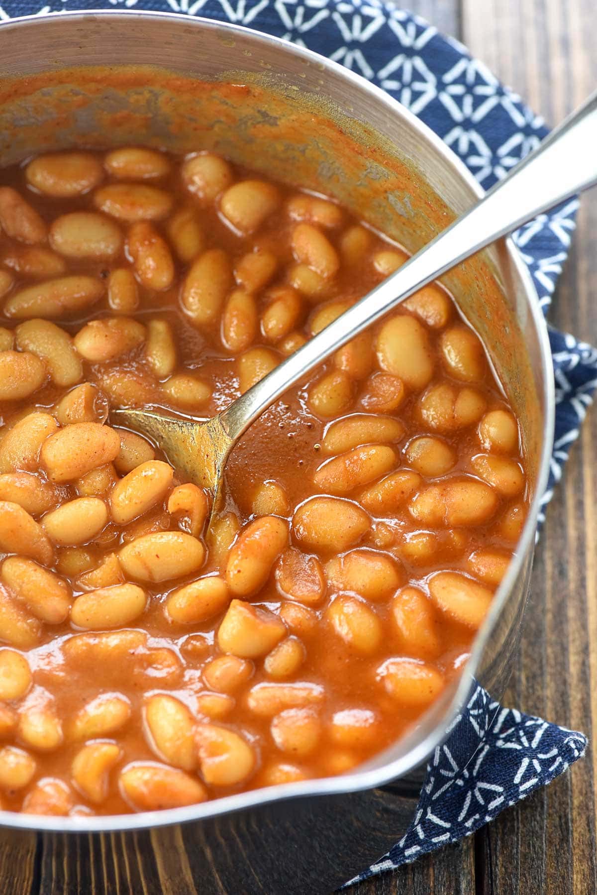 Easy Baked Beans in pot with spoon.