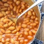 Easy Baked Beans aerial close-up in pot with spoon.