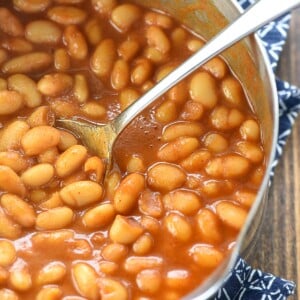 Easy Baked Beans aerial close-up in pot with spoon.