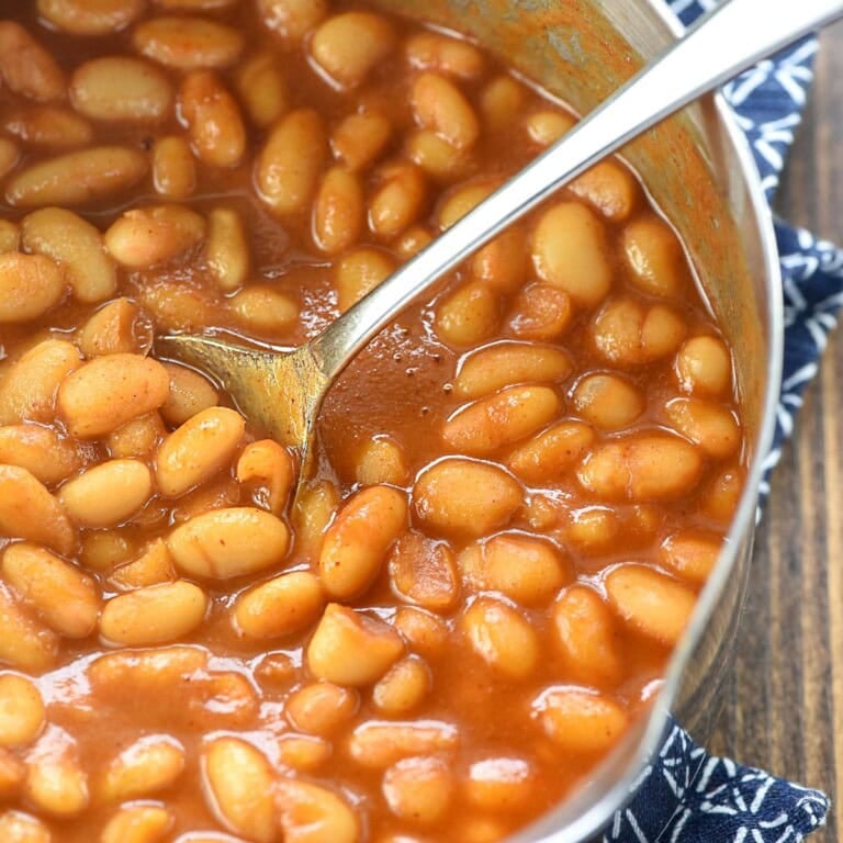 Easy Baked Beans aerial close-up in pot with spoon.