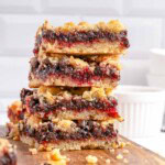 Raspberry Bars stacked on board.