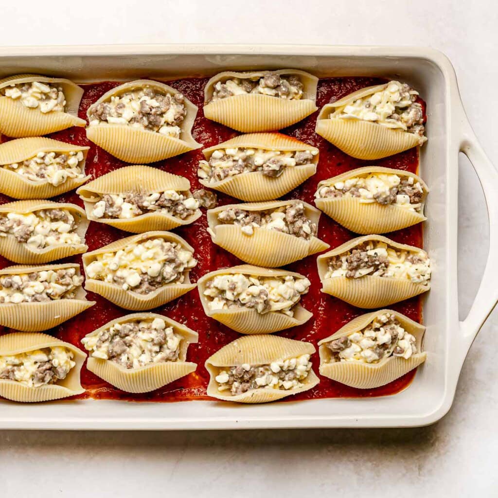 Stuffed shells with meat and ricotta ready for sauce.