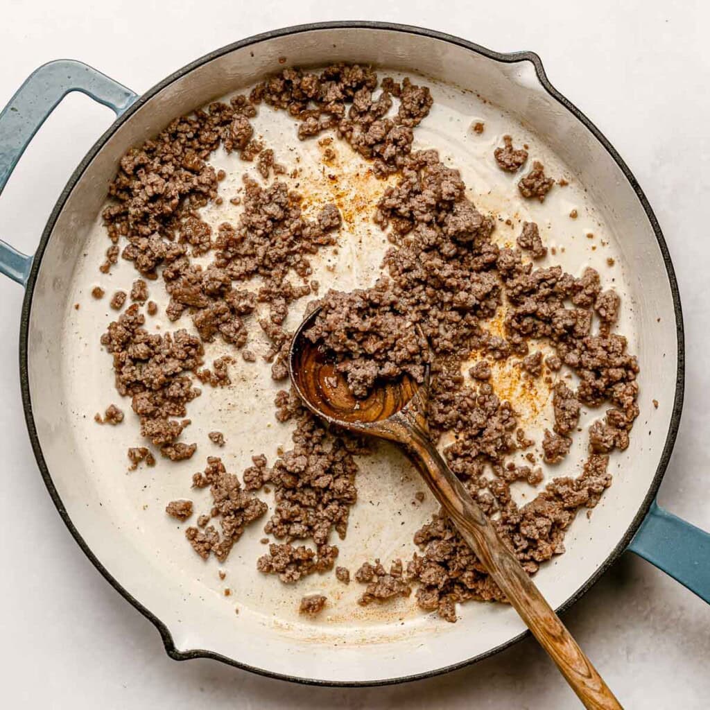 Ground beef browned in skillet.