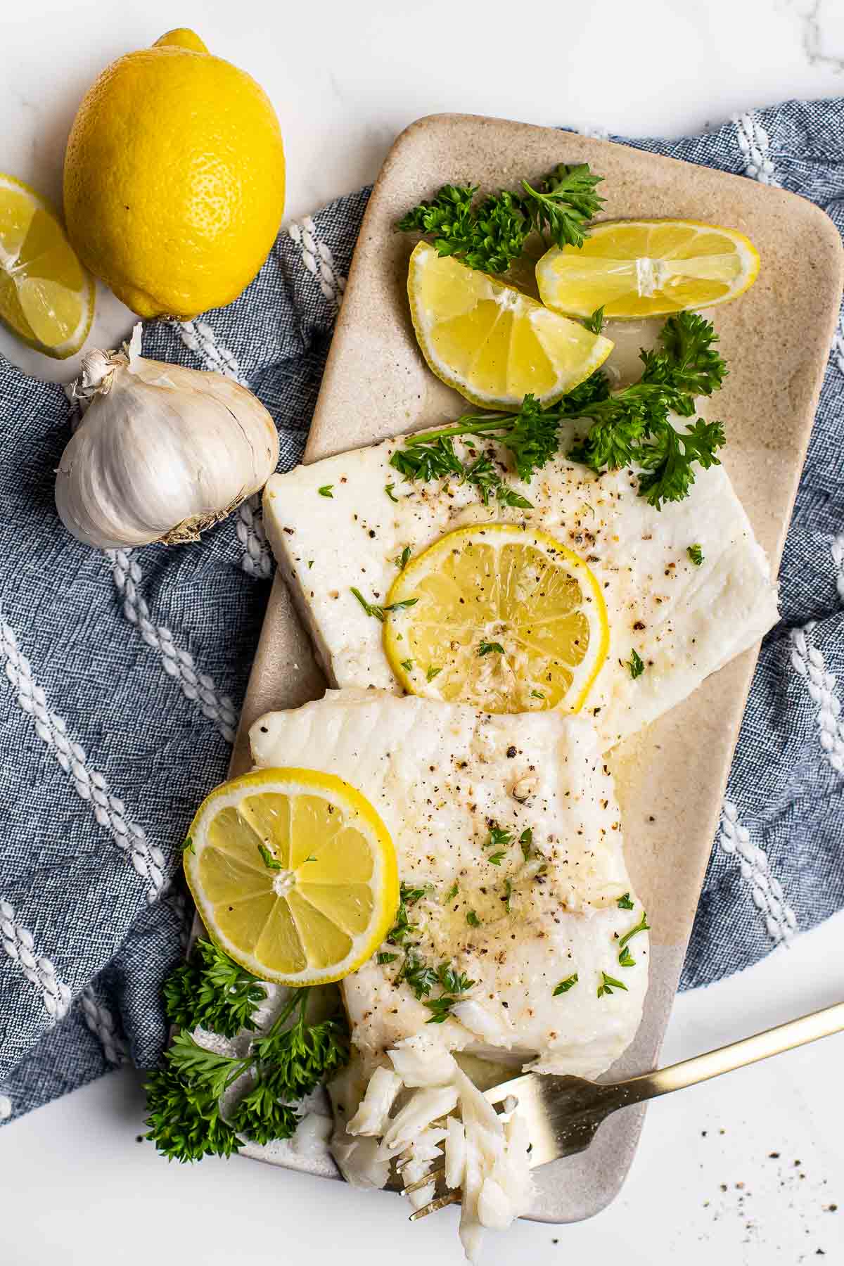 Baked Halibut with bite on fork.