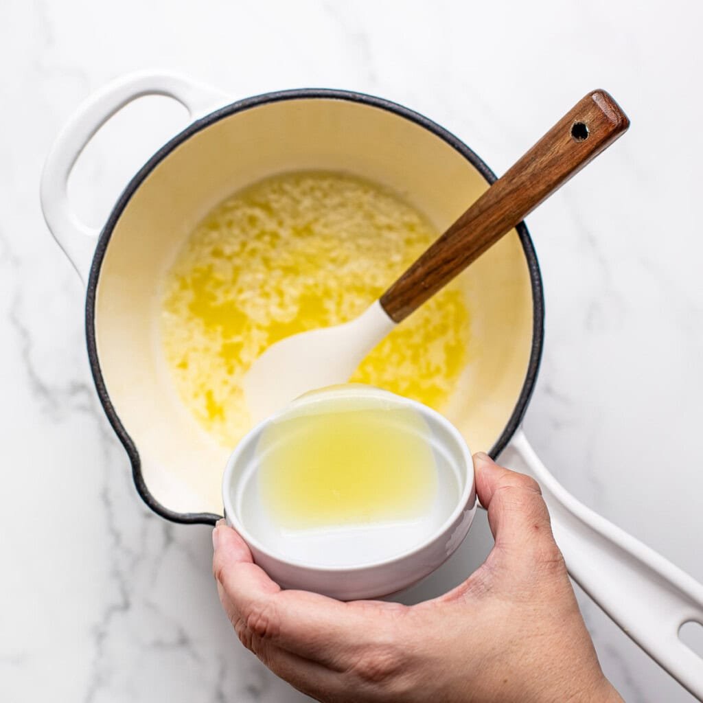 Adding lemon juice to saucepan.