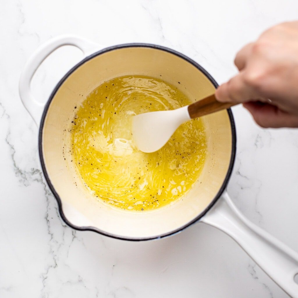 Baked halibut recipe sauce being stirred.