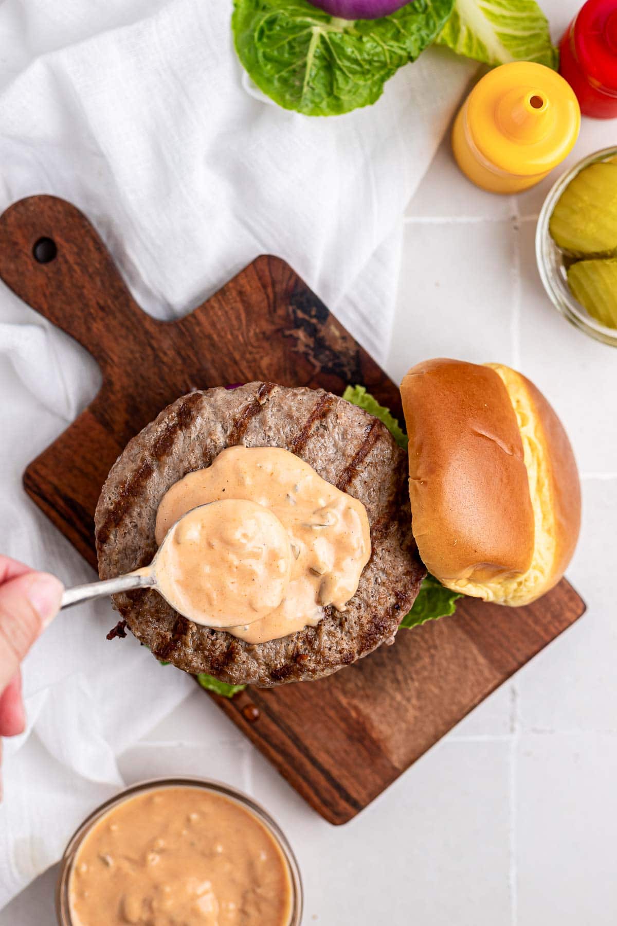 Best Burger Sauce recipe being spread onto burger.