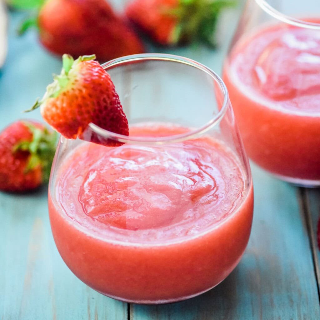 Frose recipe in glass with fresh strawberry.