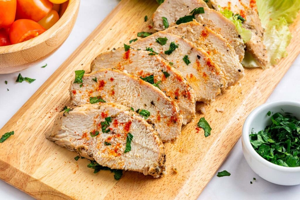 Mediterranean Chicken Marinade sliced on cutting board.