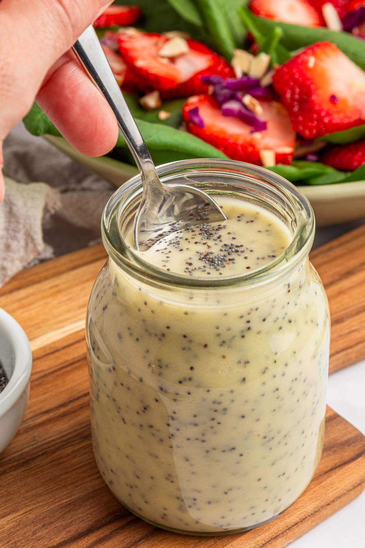 Poppy Seed Dressing recipe with spoon dipped in it.