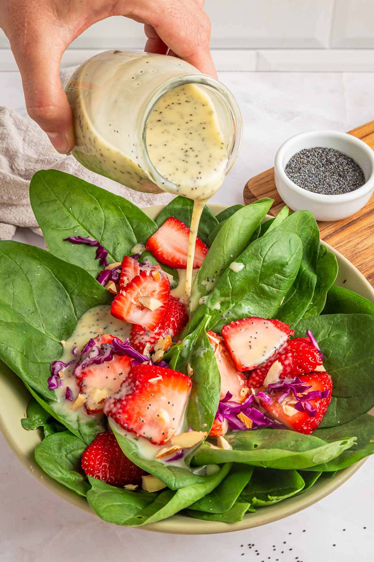 Poppy Seed Salad Dressing poured over salad.