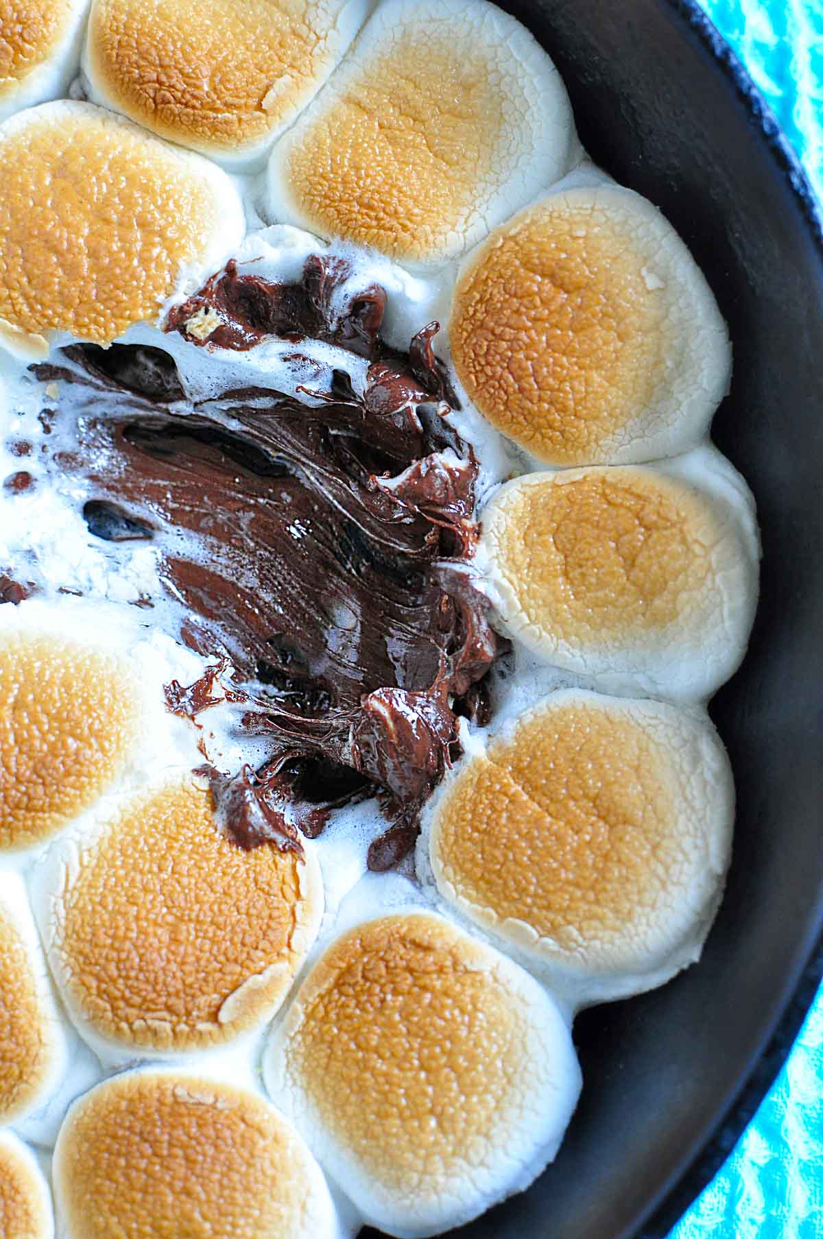 S'mores Dip zoom aerial close-up with missing marshmallows.
