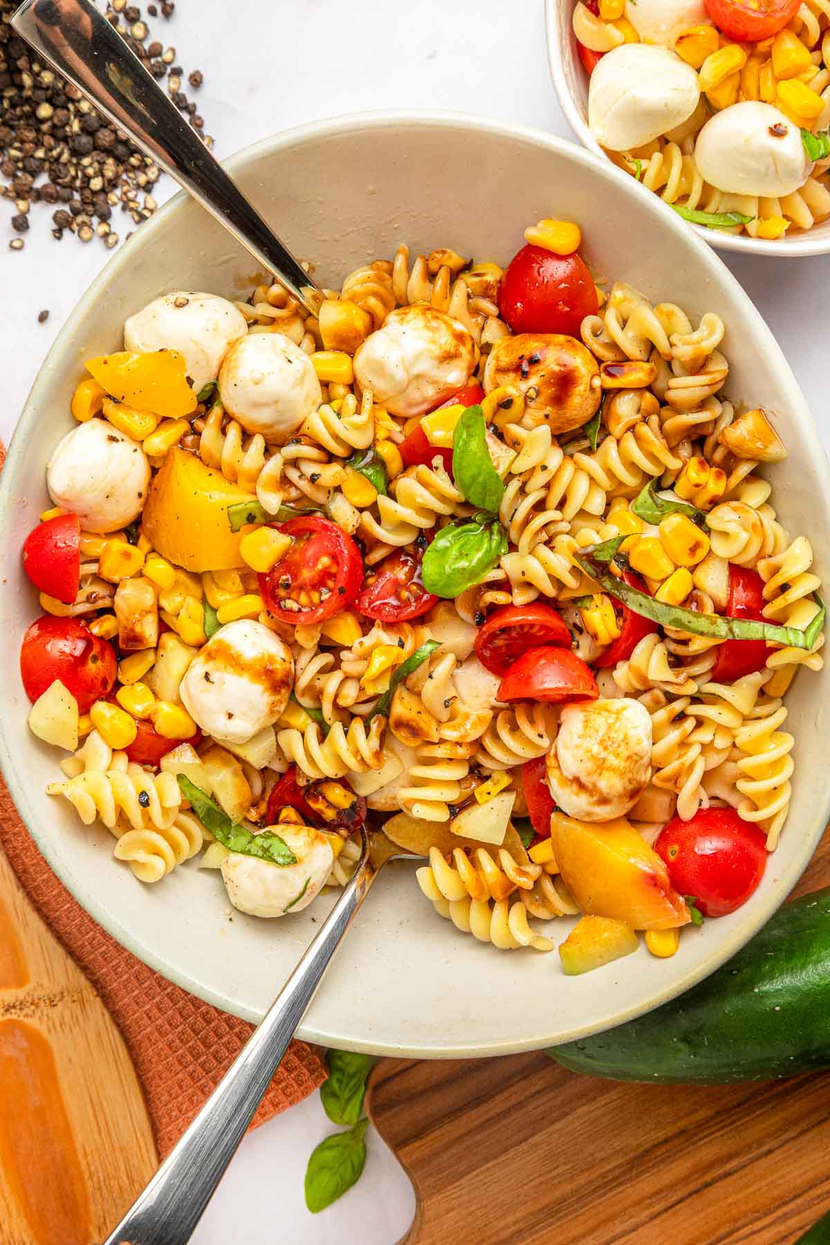 Summer Pasta Salad with two spoons inserted.
