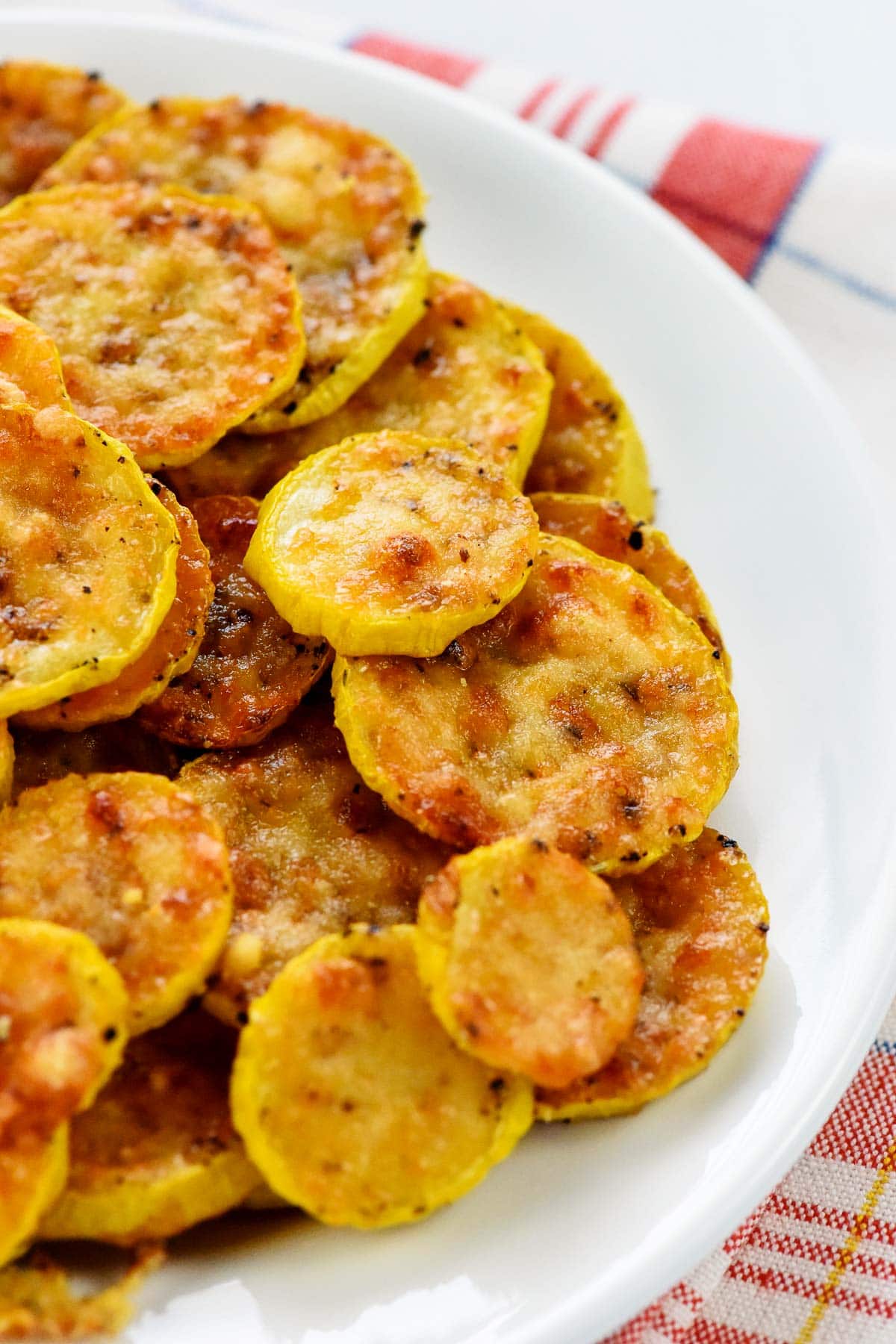 Baked yellow squash recipe close-up on plate.