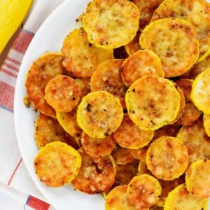 Baked yellow squash recipe, aerial close-up view on plate.