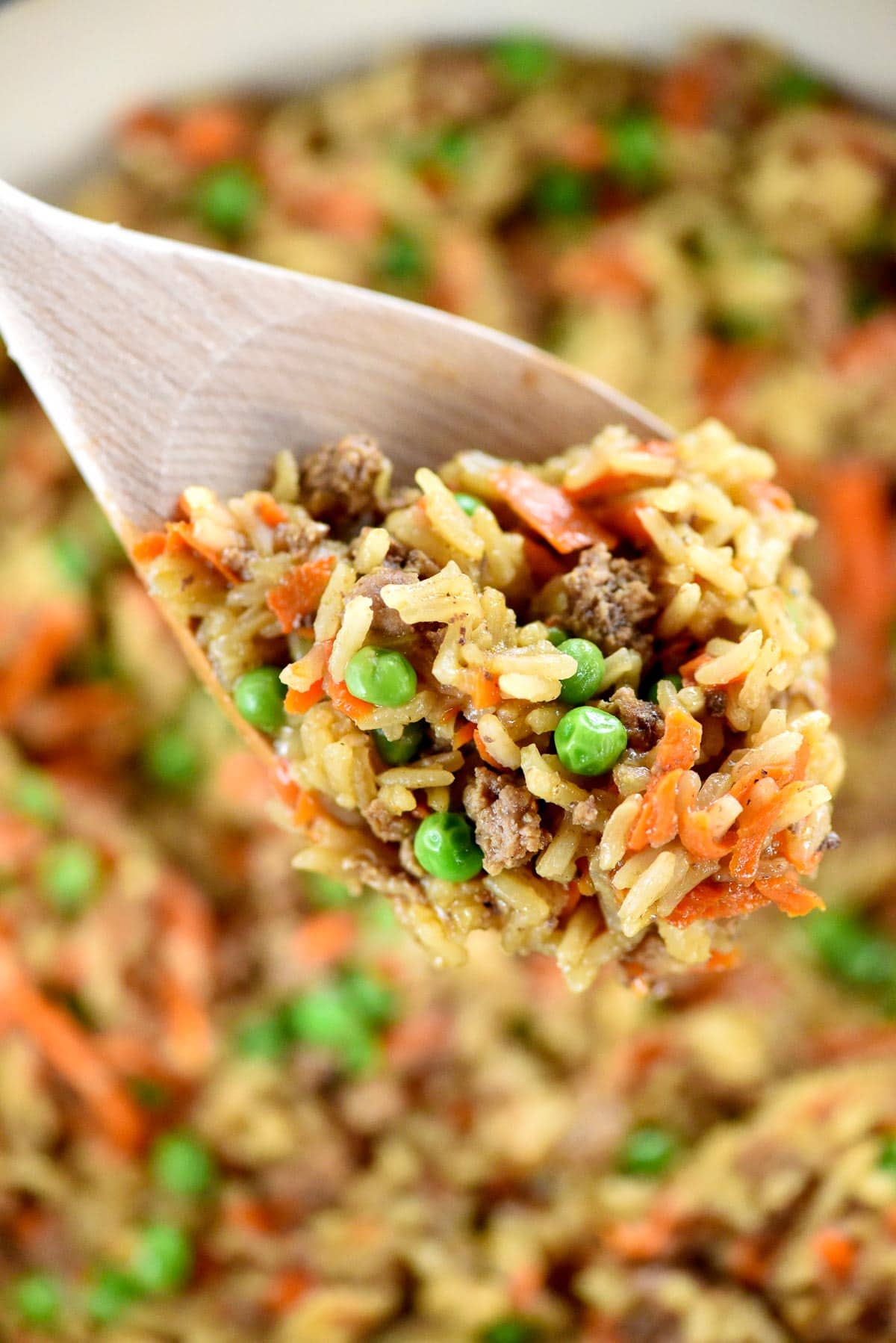 Asian ground beef on wooden spoon.