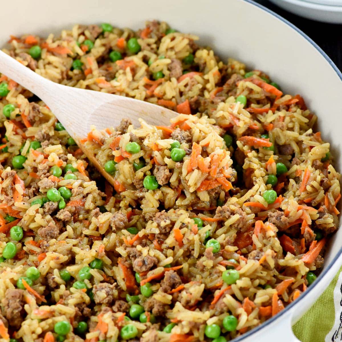 Asian Ground Beef and Rice recipe in pan with wooden spoon.