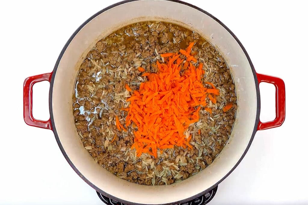 Adding carrots to Asian Ground Beef and Rice.