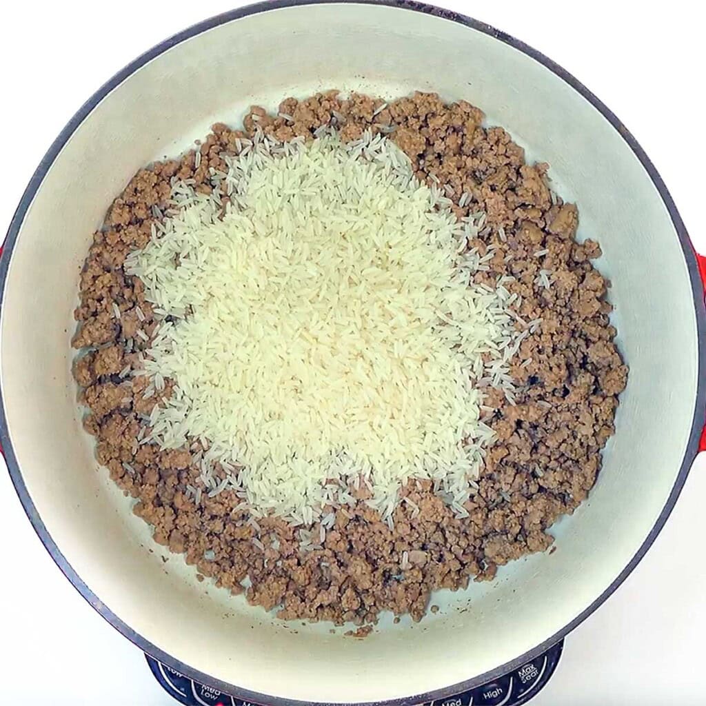 Adding rice to pot for Asian ground beef.
