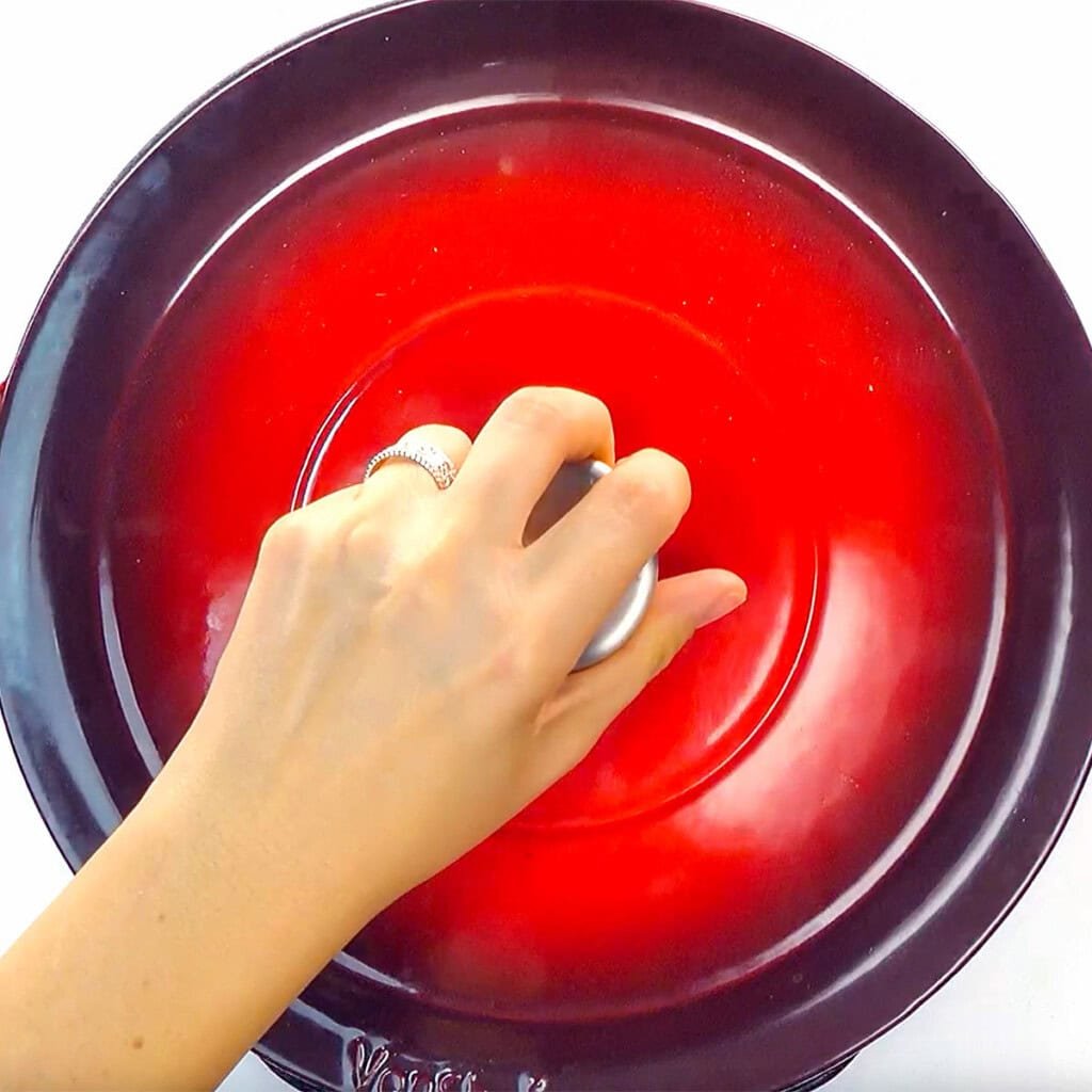 Adding lid to pot.
