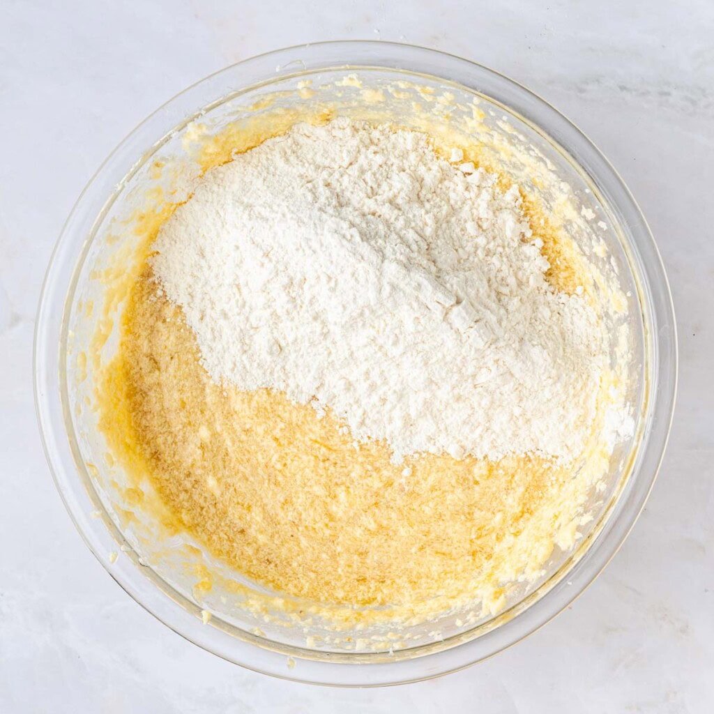 Adding flour mixture to bowl.