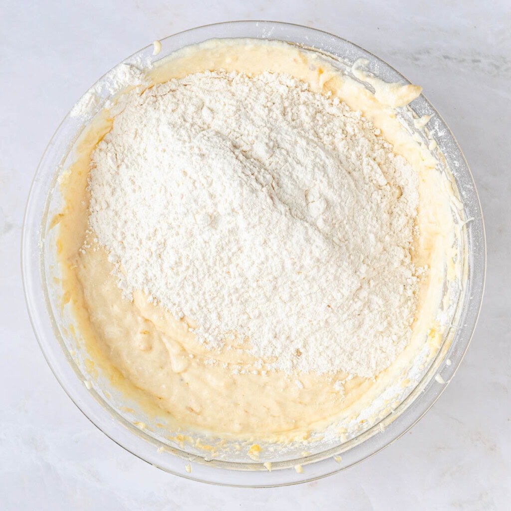 Adding remaining flour to Banana Chocolate Chip Cake batter.