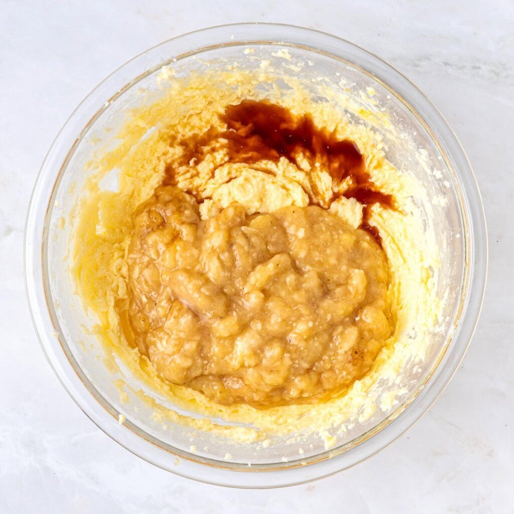 Adding bananas and vanilla for Banana Chocolate Chip Cake.