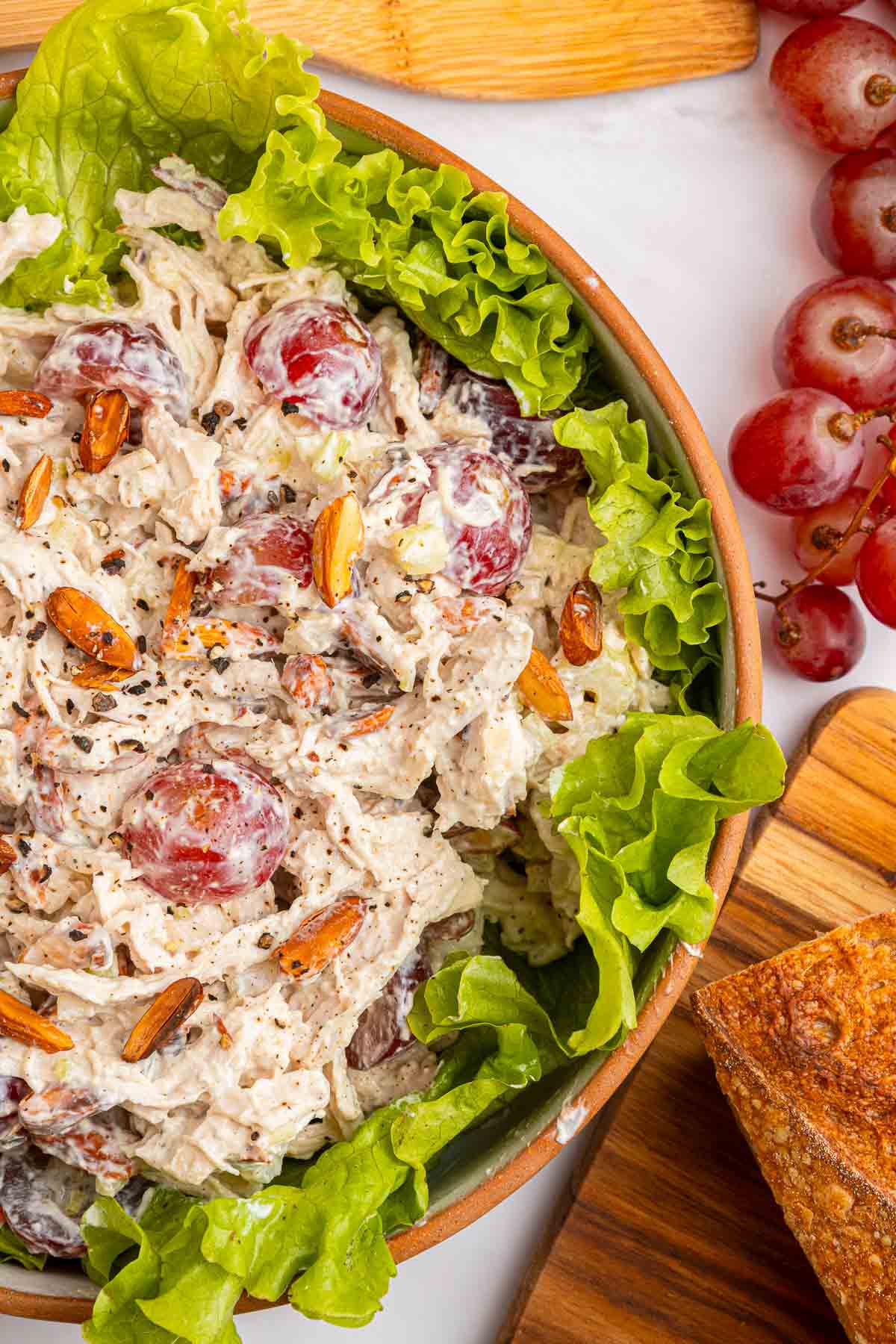 Chicken salad recipe with grapes, aerial zoom in bowl.