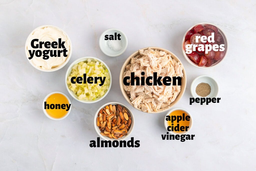 Labeled ingredients to make chicken salad recipe with grapes.