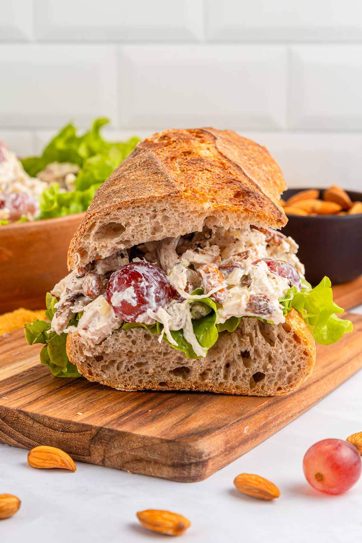 Chicken Salad with Grapes sandwich on wooden board.