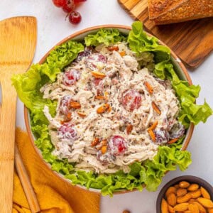 Chicken Salad with Grapes, aerial in bowl with lettuce and other ingredients on table.