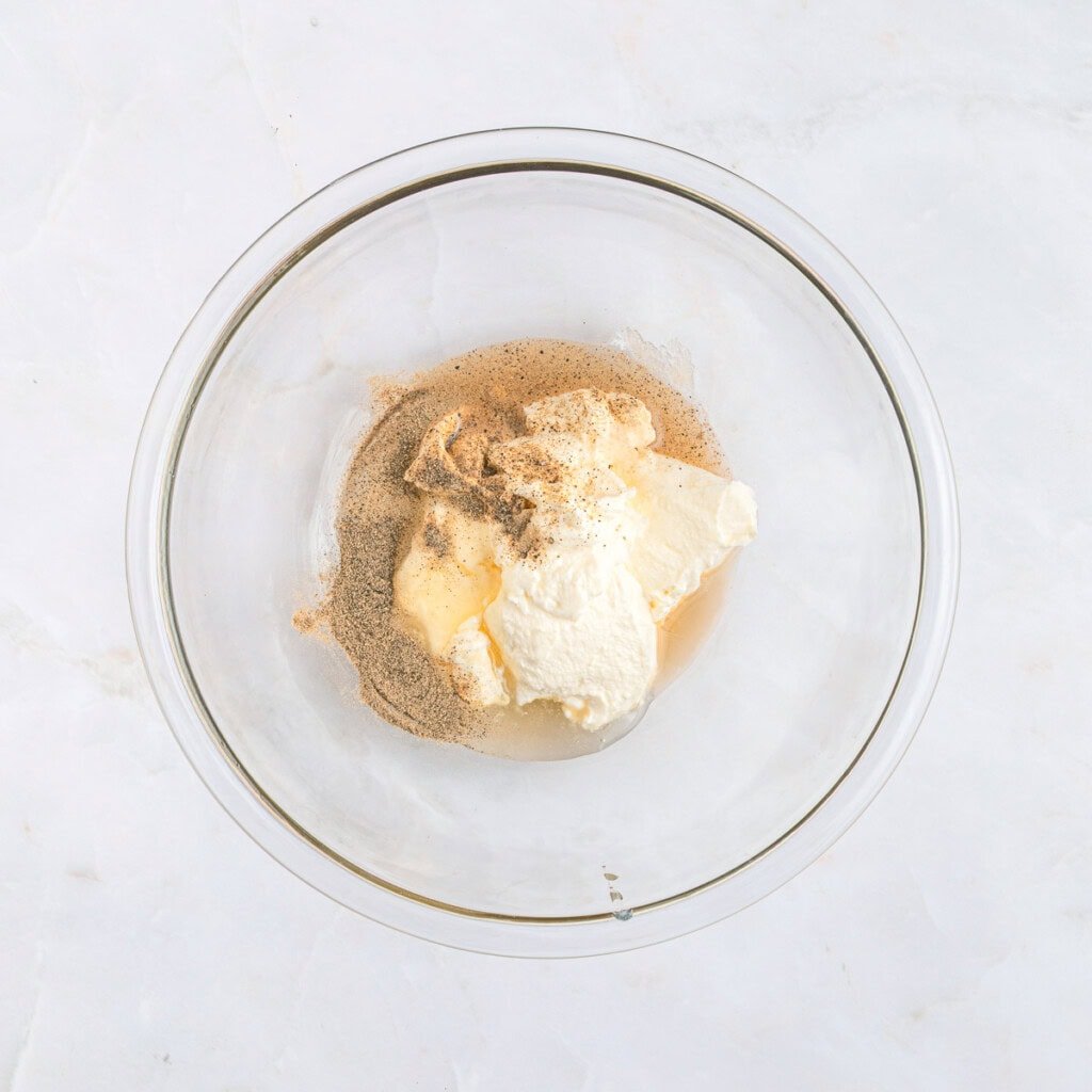 Dressing ingredients in glass bowl.