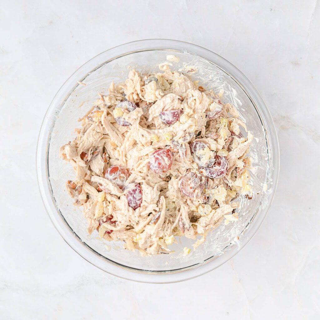 Best chicken salad recipe with grapes in glass bowl.