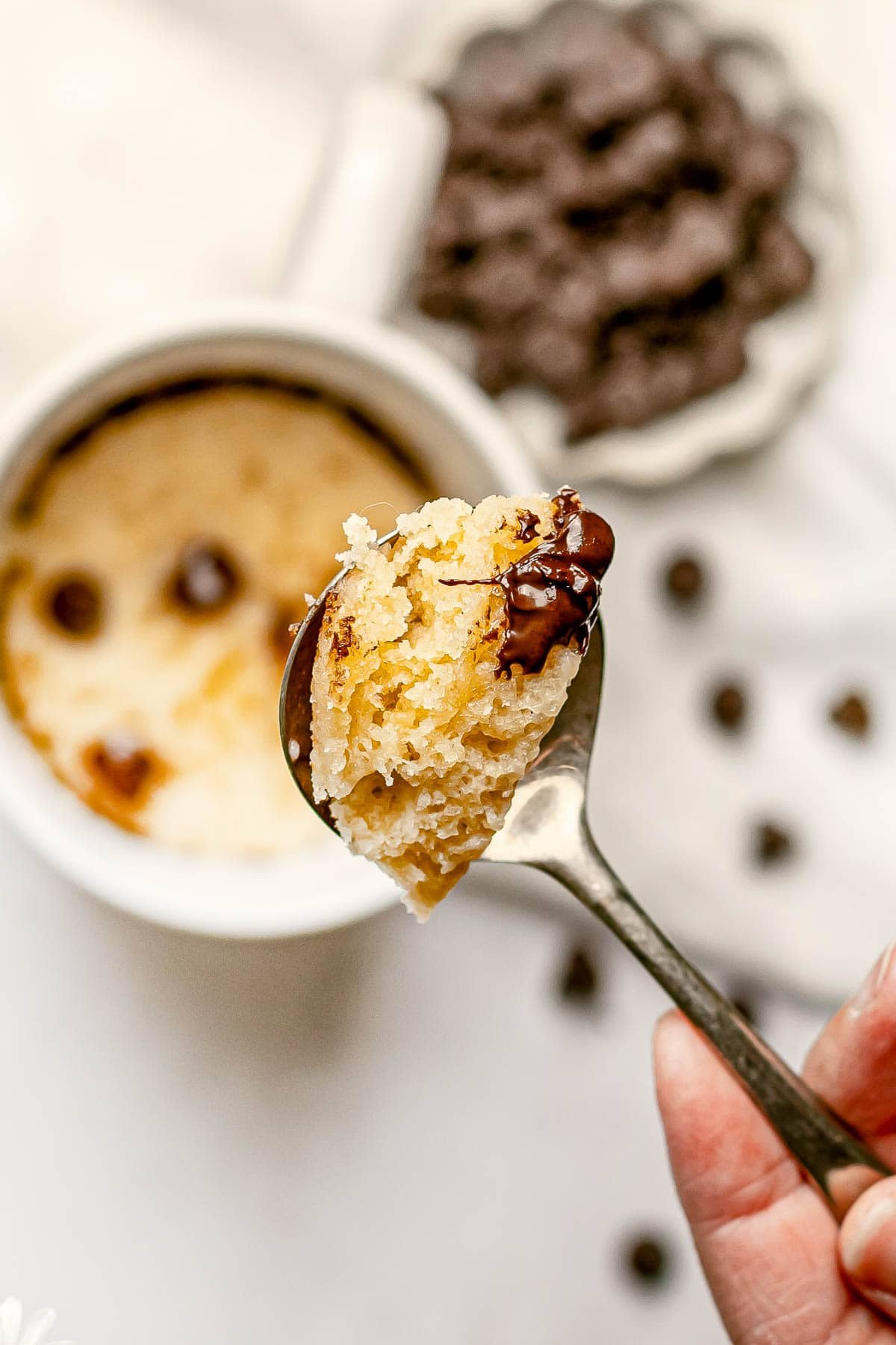 Chocolate Chip Mug Cake recipe with bite on spoon.