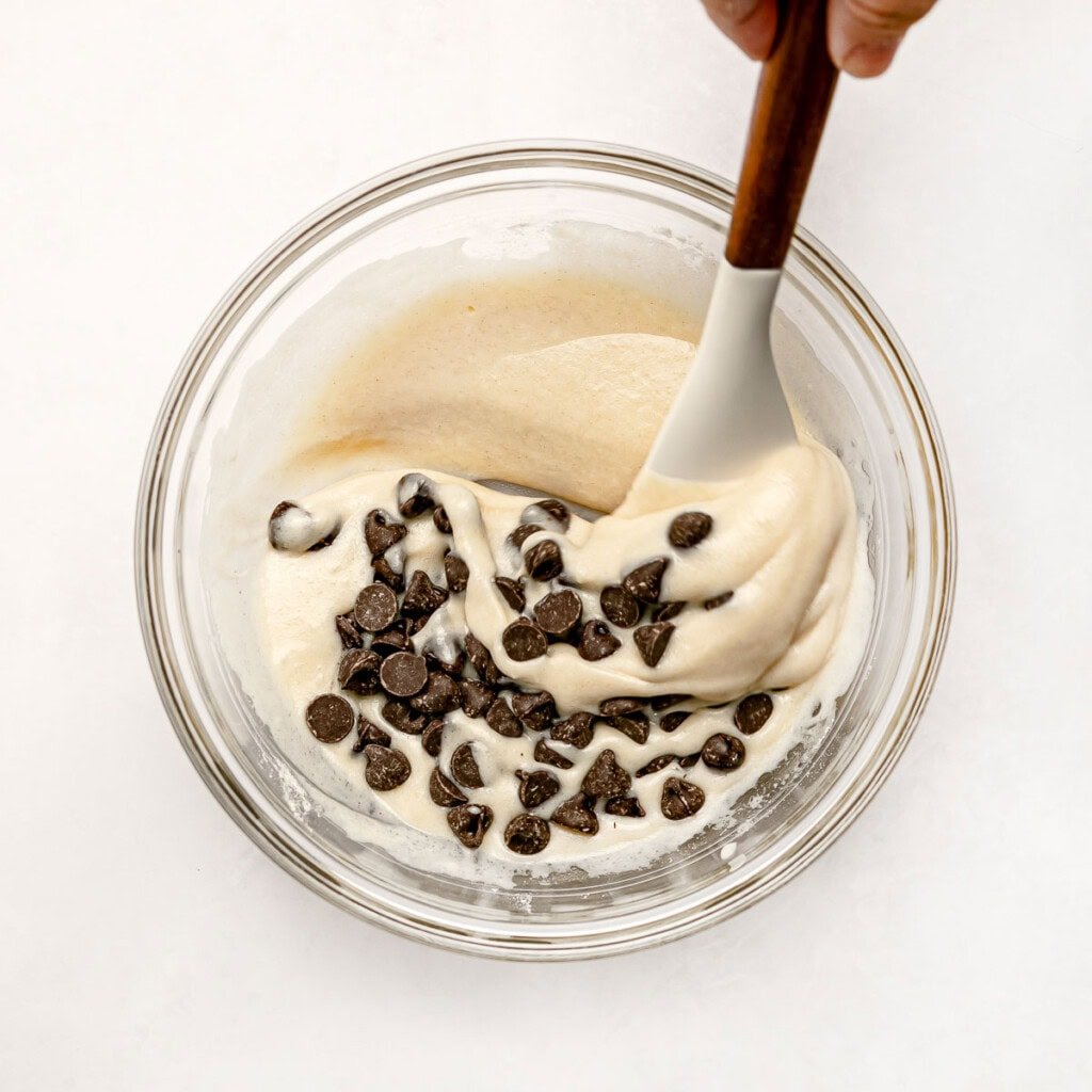 Adding chocolate chips to Chocolate Chip Mug Cake batter.