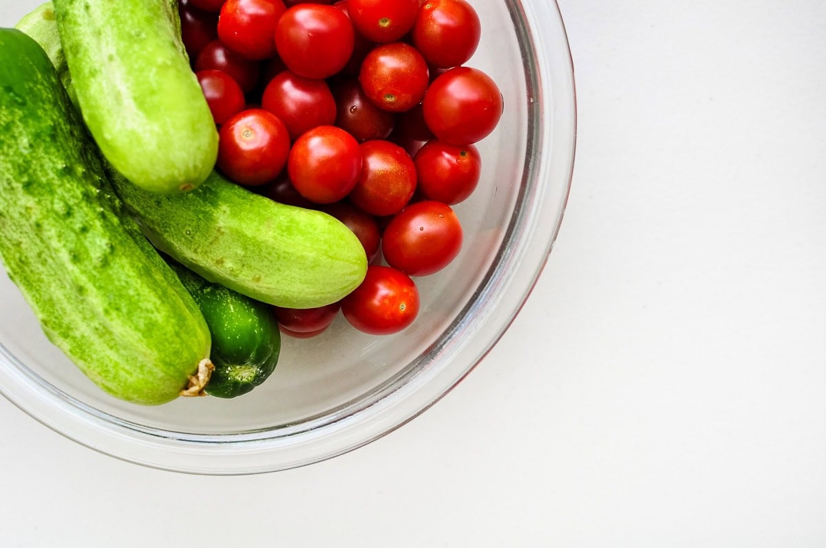 Bowl of fresh cucumbers and tomatoes for cucumber feta tomato salad.