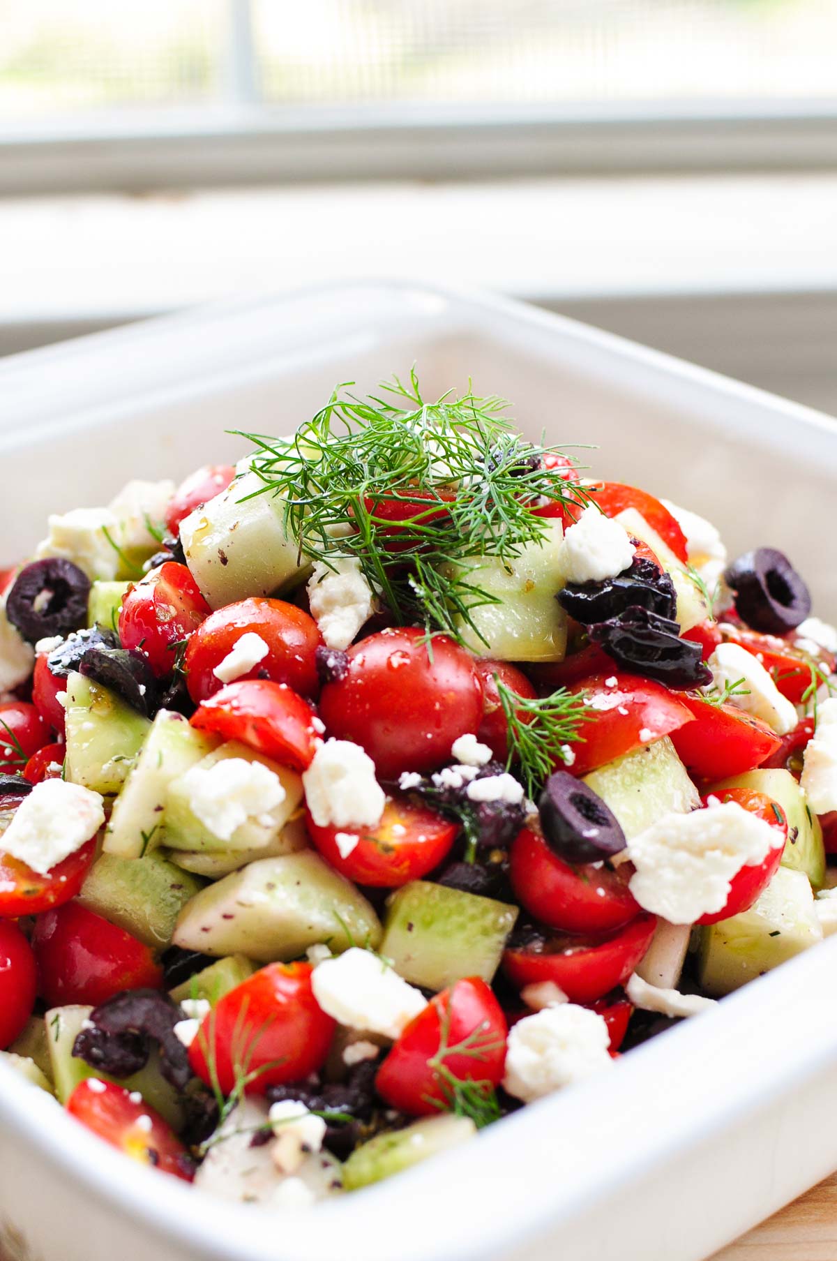 Cucumber Tomato Feta Salad in white bowl.