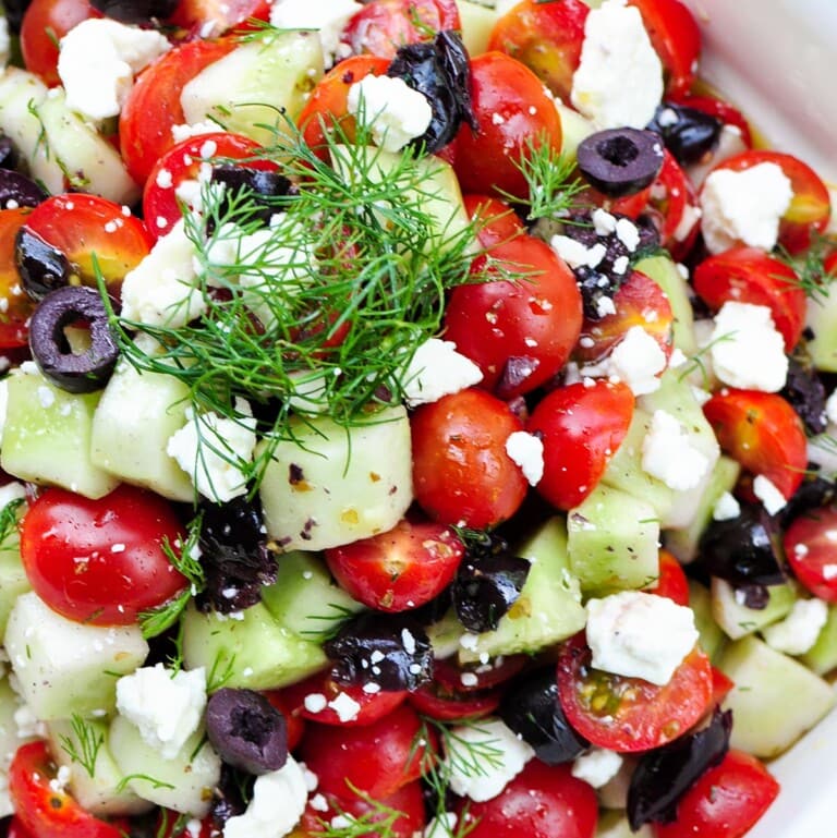 Cucumber Tomato Feta Salad, aerial close-up with olives and dill.