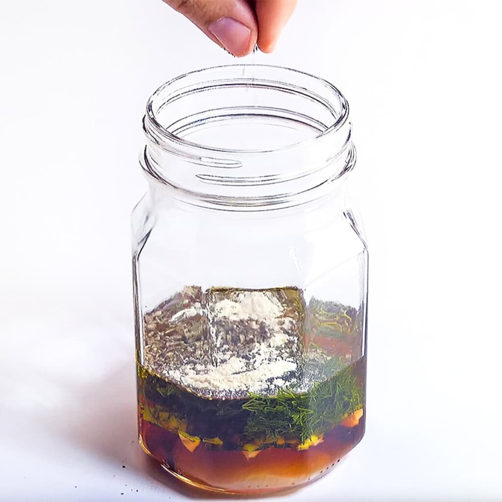 Adding dill, herbs, and spices.