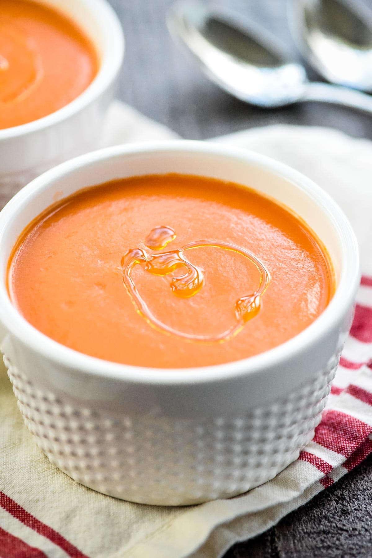 Gazpacho recipe with spoons in background.
