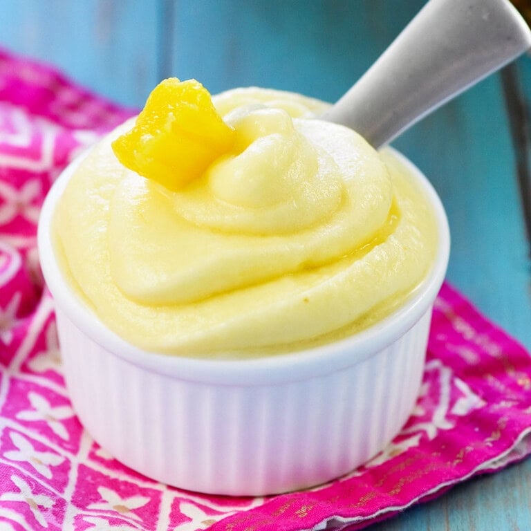 Pineapple Dole Whip in bowl with pineapple chunk garnish.