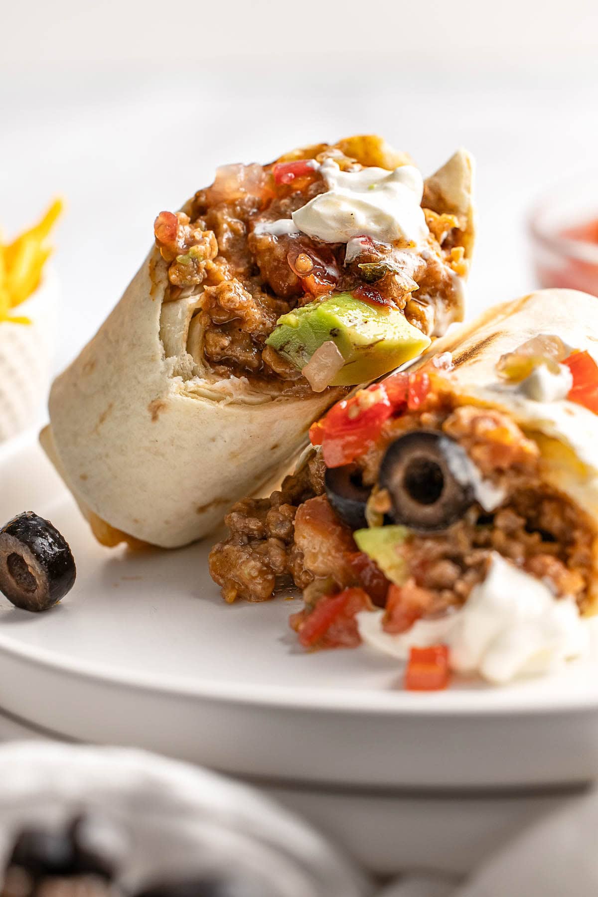 Beef and Bean Burritos garnished with toppings.